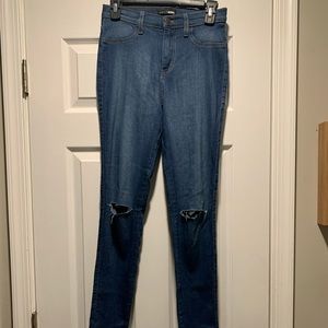 Fashion Nova Medium wash skinny Jean size 13 with slits in knees